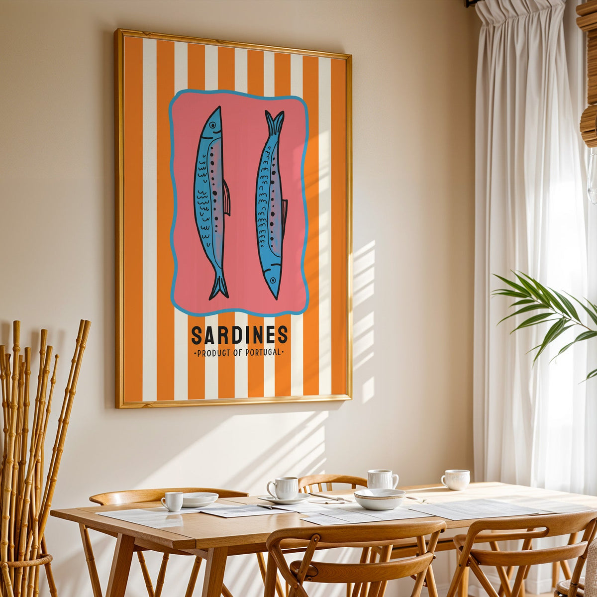 Sardines of Portugal print in a gold frame above a sunlit breakfast table