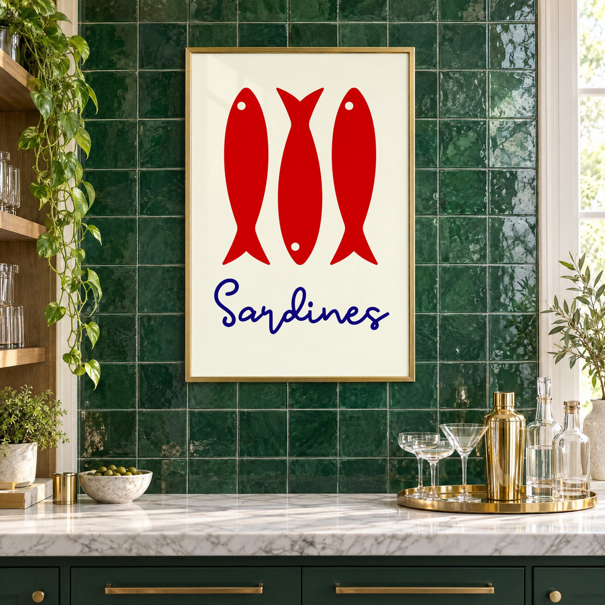Three red sardines print in a brass frame on emerald green tiles above a home bar with coupe glasses