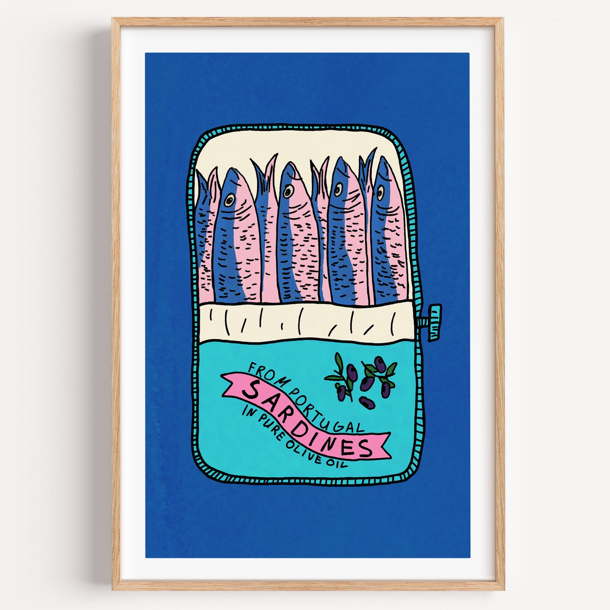 Blue sardine tin print in a light oak frame on a plain white wall