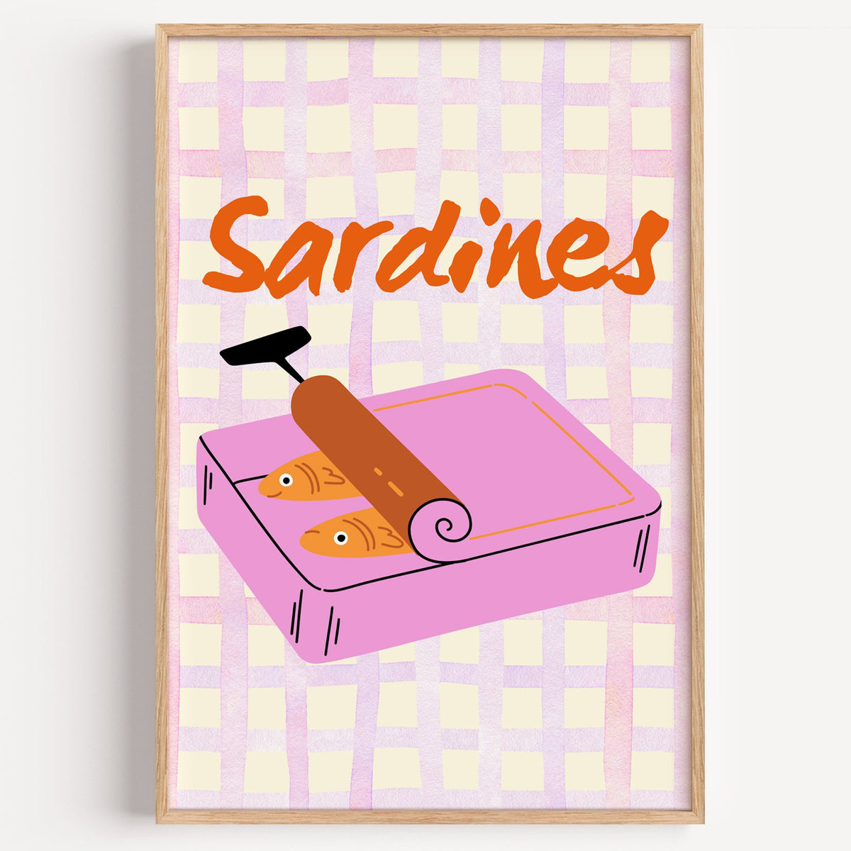 Sardines pink tin on gingham print in a light oak frame on a plain white wall