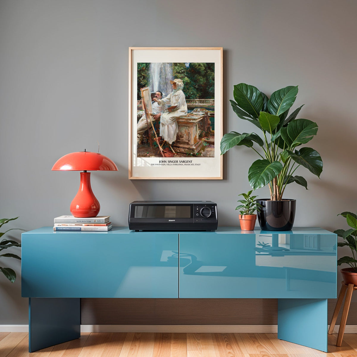 Sargent print in an oak frame above a teal sideboard with a red lamp