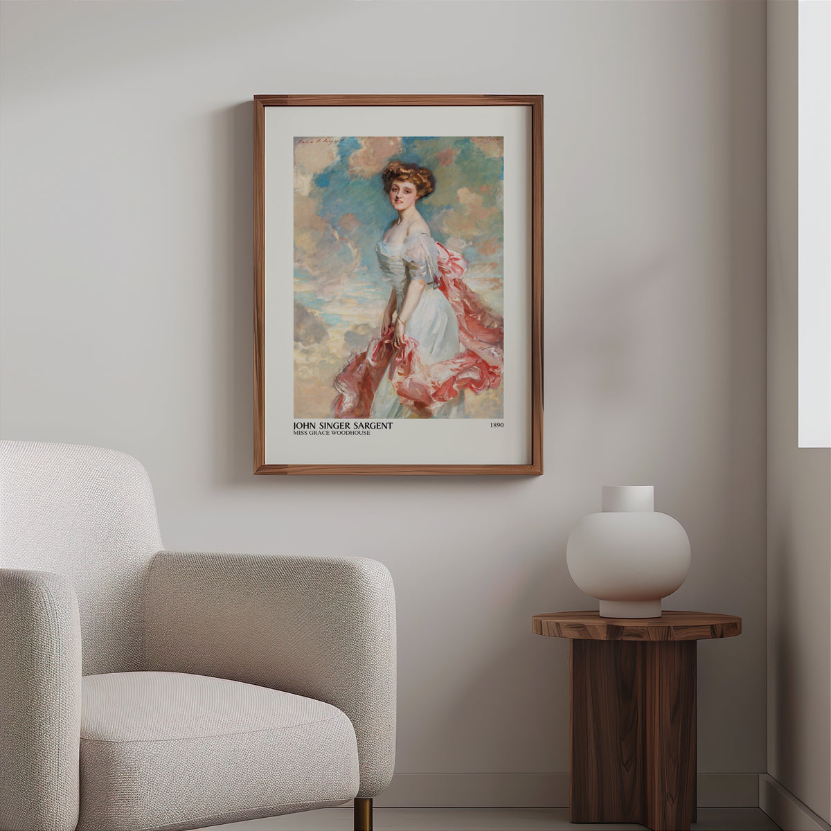 Woman in a white gown portrait print in a slim walnut frame above a bouclé armchair