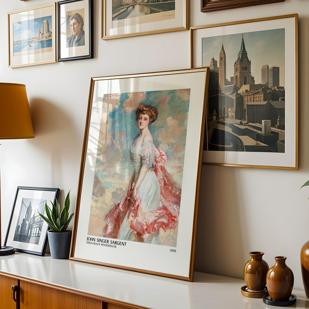 Edwardian portrait print shown in a gold frame leaning on a sideboard in a gallery wall