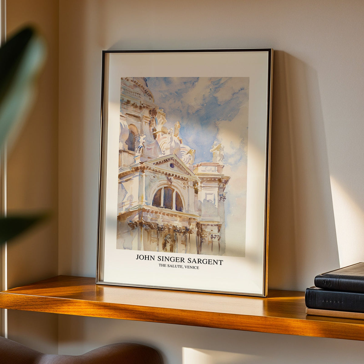 Venice church watercolour print in a black frame on a walnut shelf in evening light