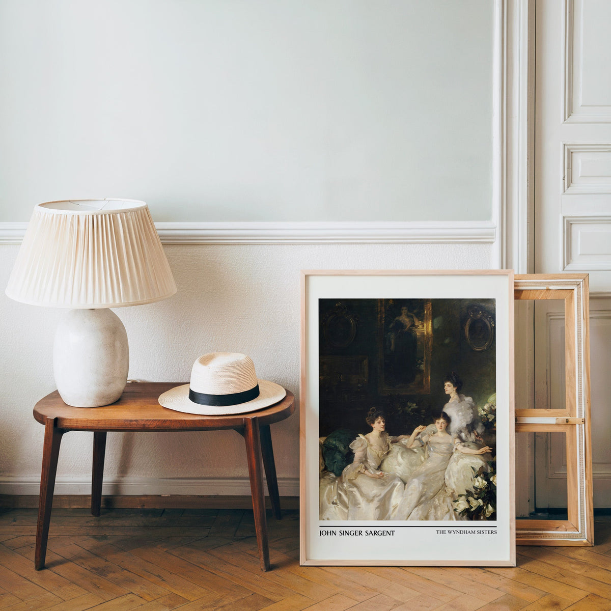 Edwardian society poster in a light wood frame leaning by a bench and hat