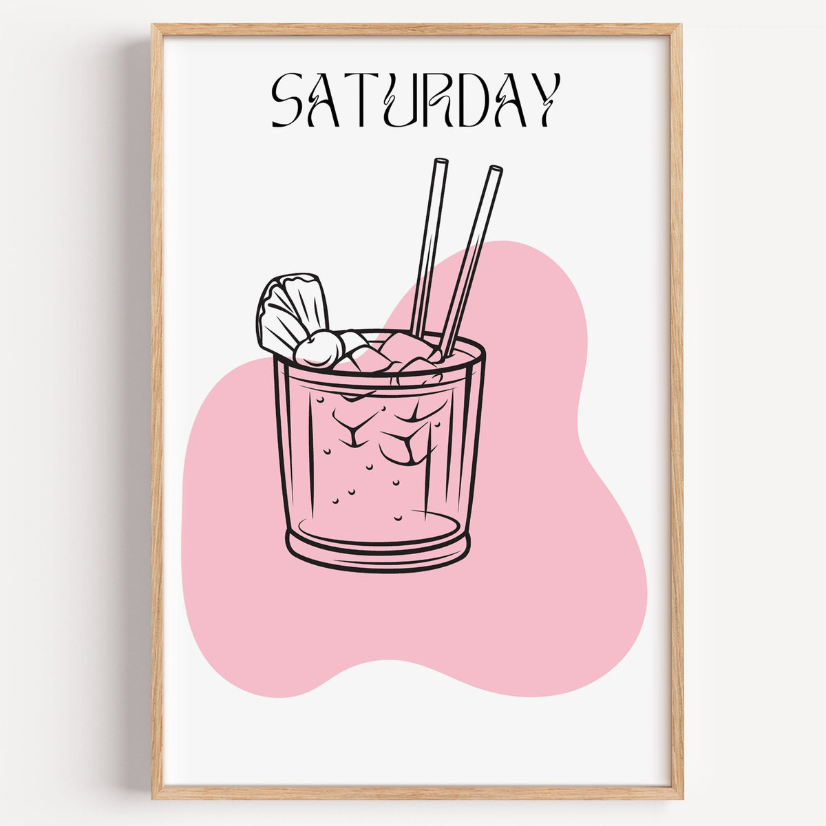 SATURDAY iced cocktail two straws print in a light oak frame on a plain white wall