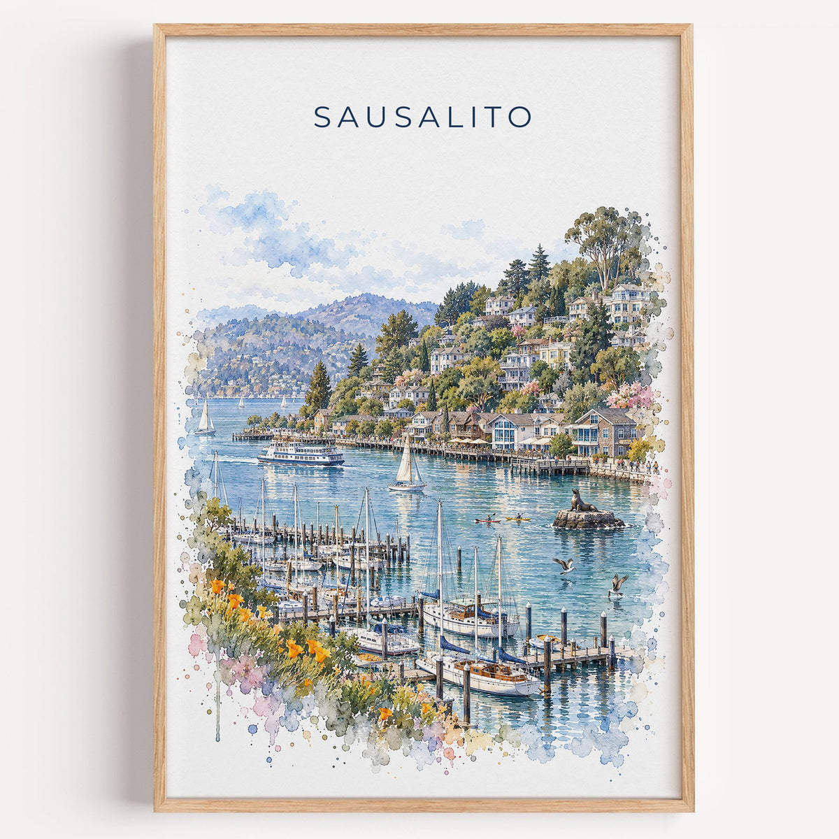Sausalito watercolor print in a light oak frame on a plain white wall