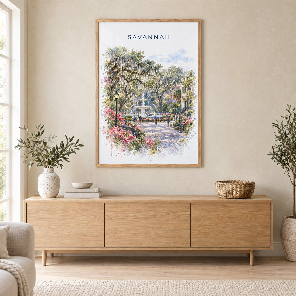 Savannah watercolor print in an oak frame above a light wood sideboard in a Scandinavian living room