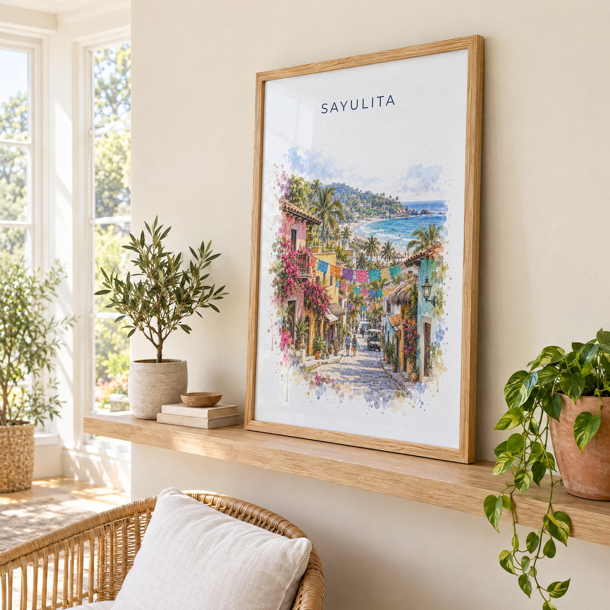 Sayulita watercolor print in an oak frame on a picture ledge in a sunlit sunroom