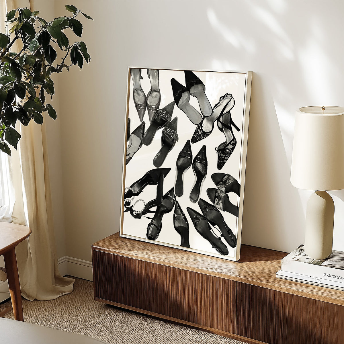 Top-down scattered pointed heels and mules print in a white frame on a walnut sideboard beside a ceramic lamp