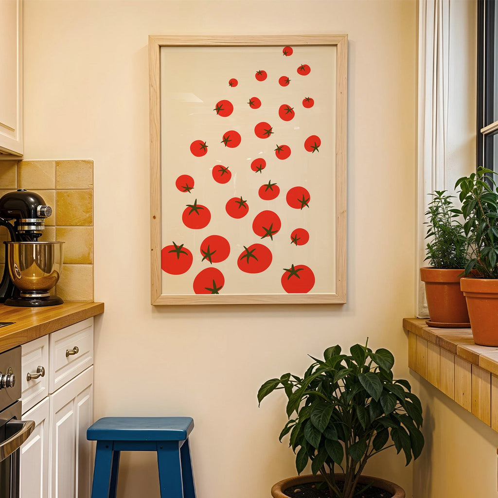 Scattered tomatoes print in a wood frame on a yellow tiled kitchen wall