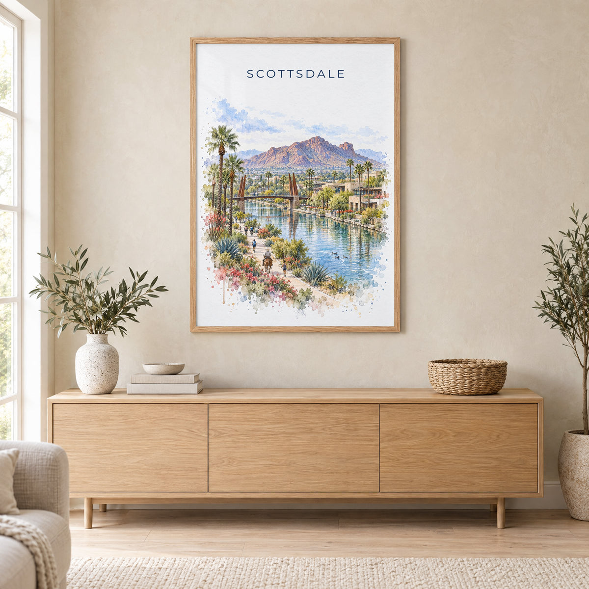 Scottsdale watercolor print in an oak frame above a light wood sideboard in a Scandinavian living room