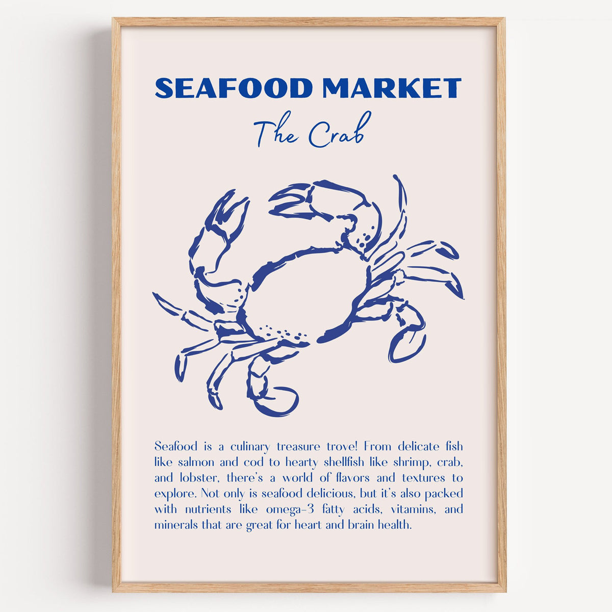 SEAFOOD MARKET The Crab cobalt sketch print in a light oak frame on a plain white wall