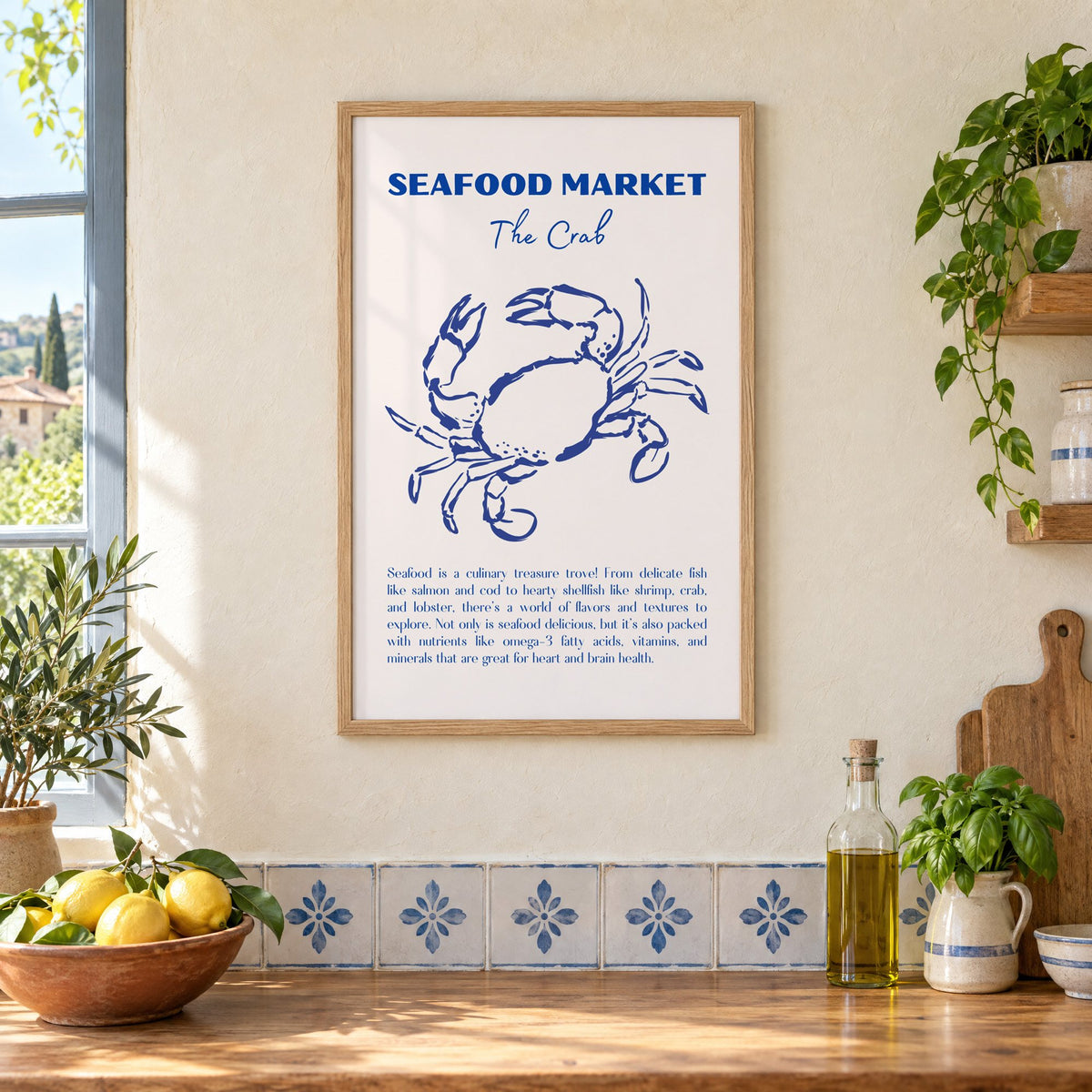 SEAFOOD MARKET The Crab cobalt sketch print in an oak frame on a cream plaster wall above a worktop with a bowl of lemons and blue-and-white tiles