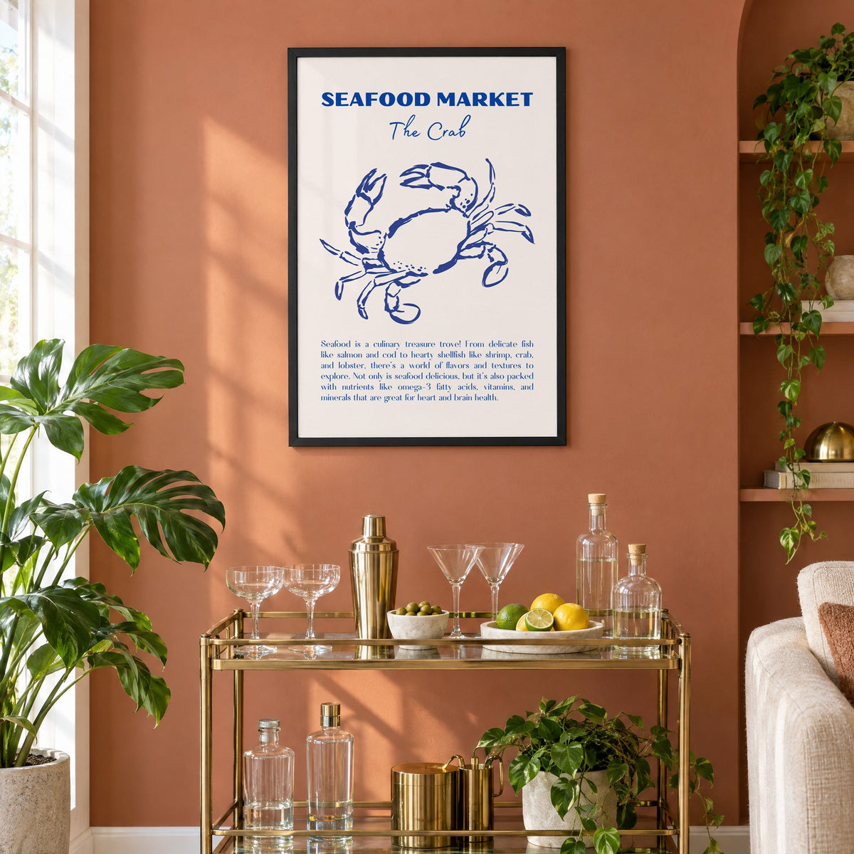 SEAFOOD MARKET The Crab cobalt sketch print in a black frame on a terracotta wall above a brass bar cart with coupes and citrus