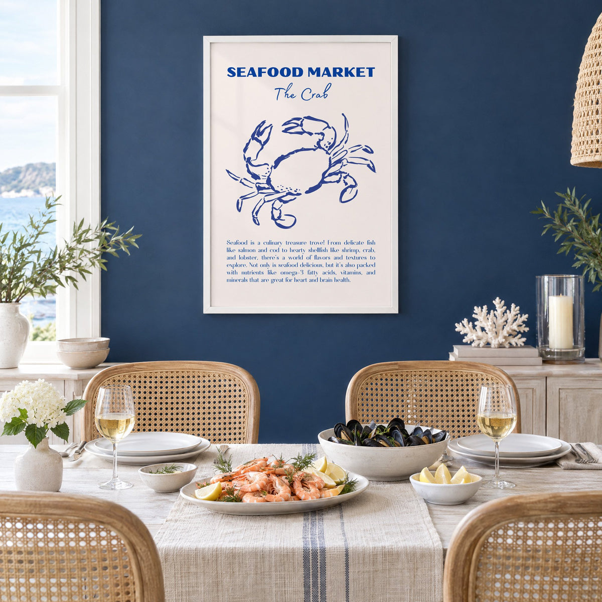 SEAFOOD MARKET The Crab cobalt sketch print in a white frame on a navy wall above a dining table set with shrimp and mussels