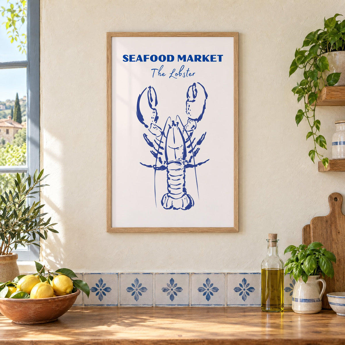 SEAFOOD MARKET The Lobster cobalt sketch print in an oak frame on a cream plaster wall above a worktop with a bowl of lemons and blue-and-white tiles