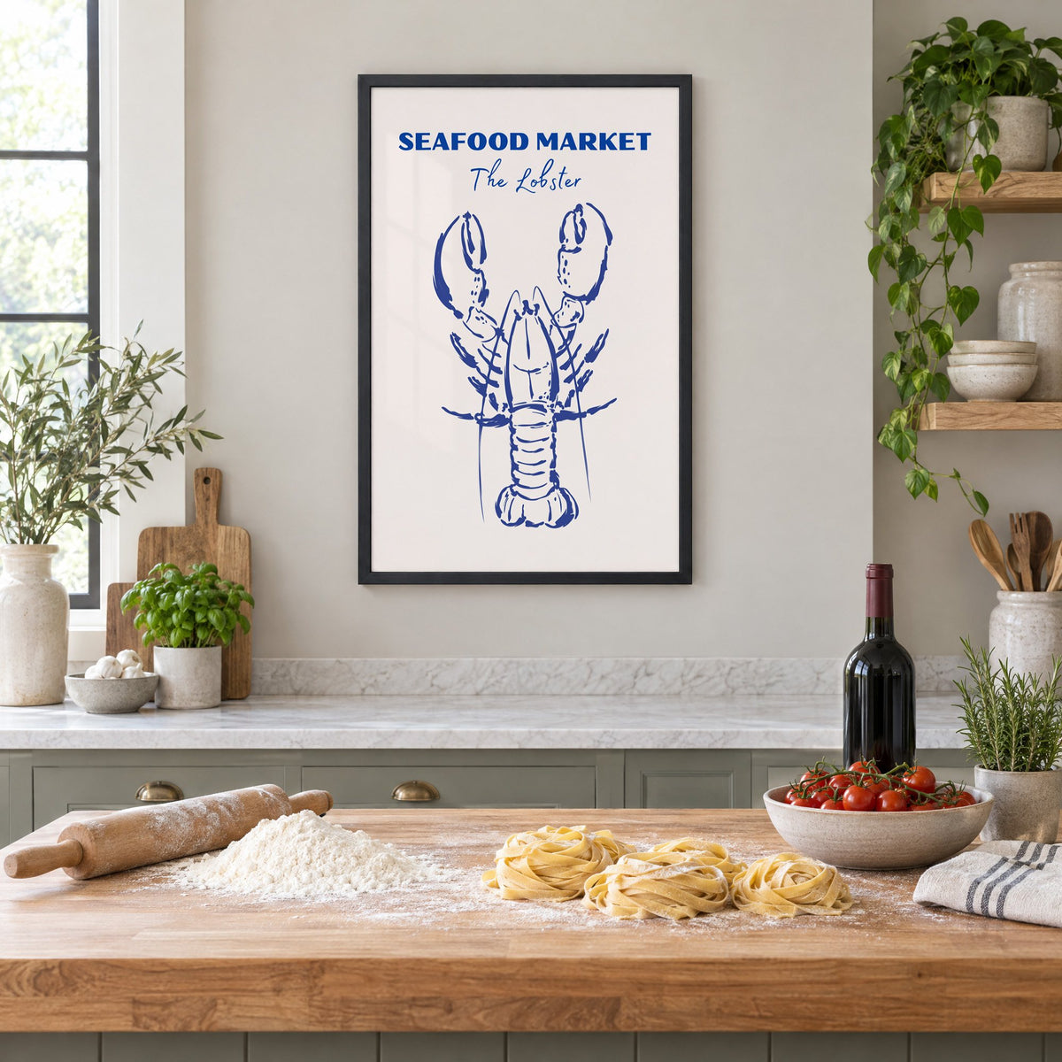 SEAFOOD MARKET The Lobster cobalt sketch print in a black frame above a butcher-block island with fresh pasta, flour and cherry tomatoes