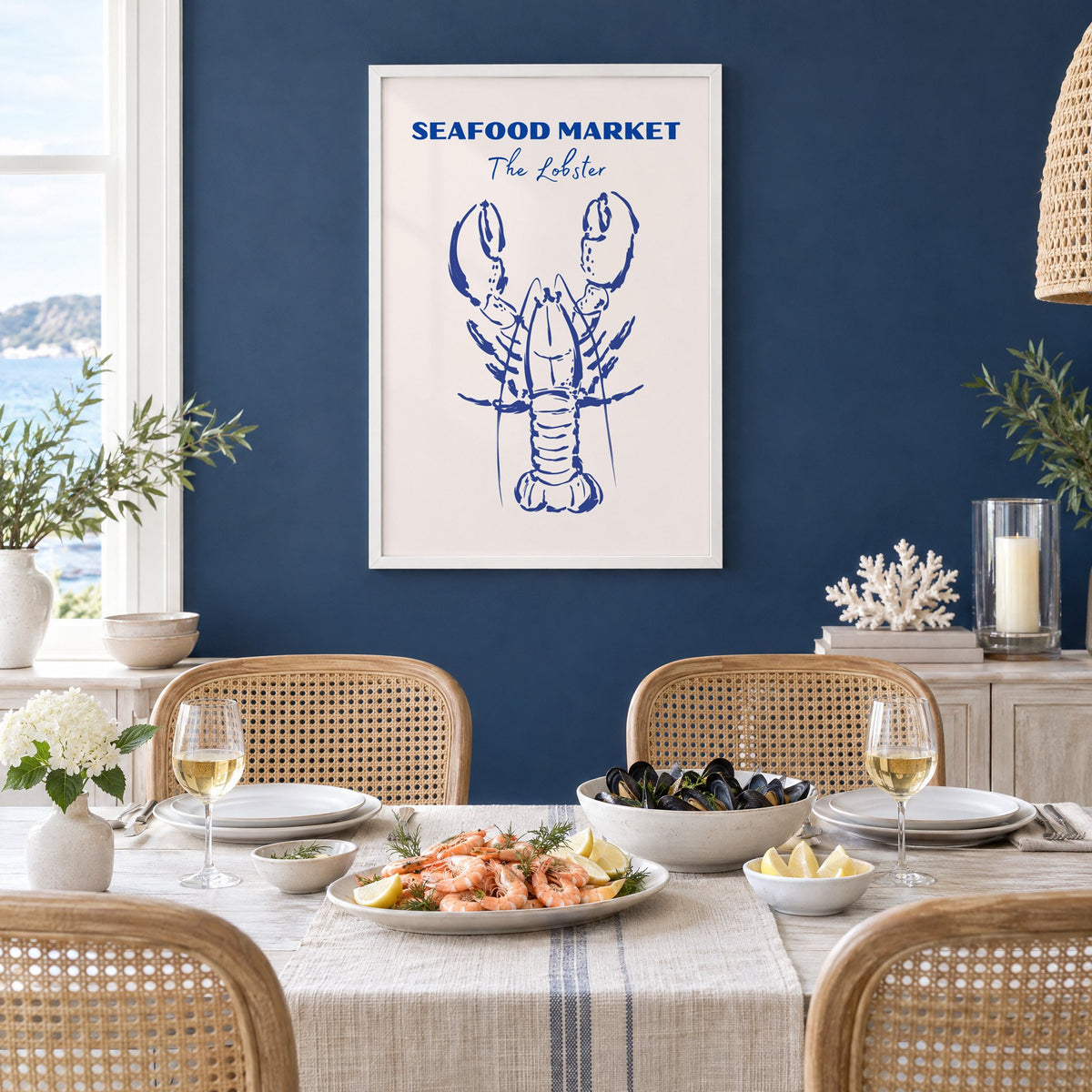 SEAFOOD MARKET The Lobster cobalt sketch print in a white frame on a navy wall above a dining table set with shrimp and mussels