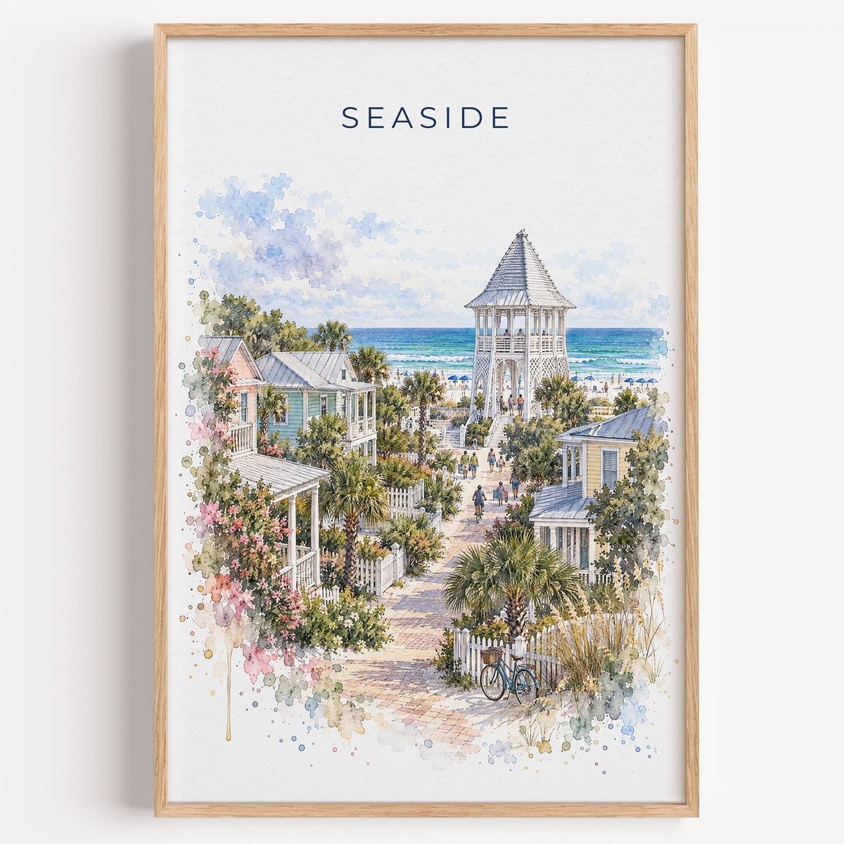 Seaside, Florida watercolor print in a light oak frame on a plain white wall