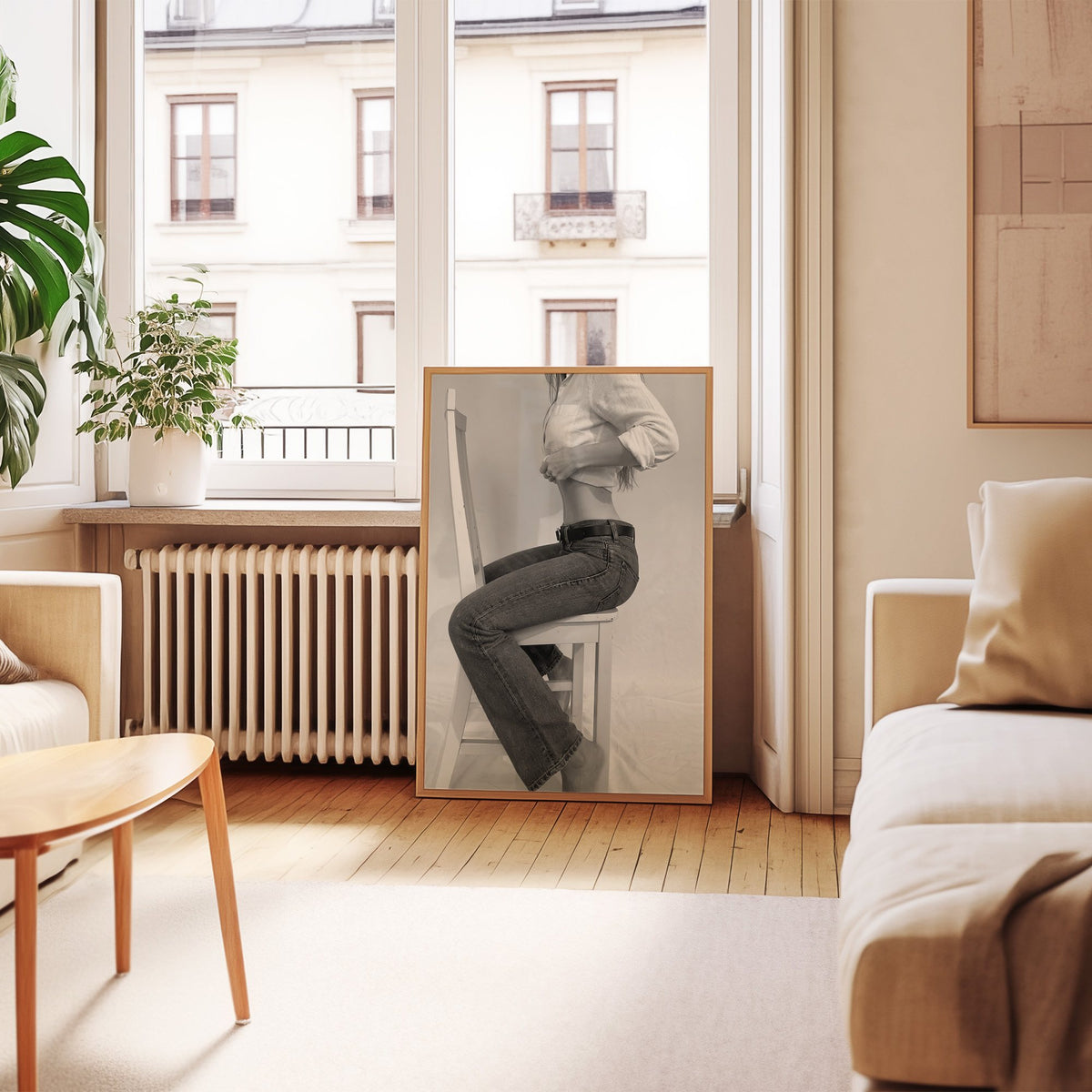 Woman in flared jeans on a white wooden chair print in an oak frame leaning by a French window in a living room