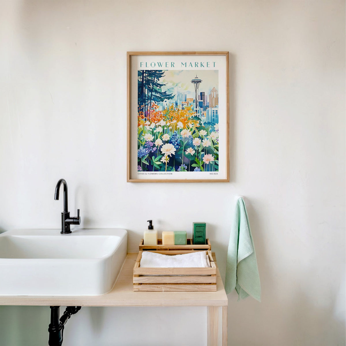 Seattle flower market print in an oak frame above a white bathroom sink with folded towels