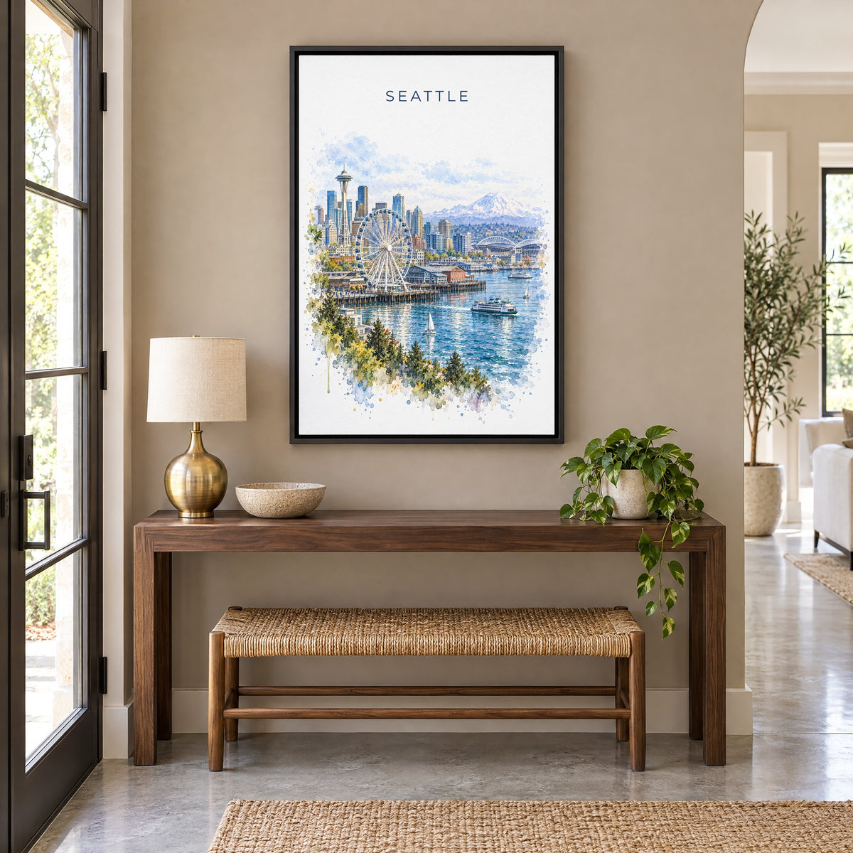 Seattle Waterfront watercolor print as a black floater canvas above a walnut console and woven bench in an entryway
