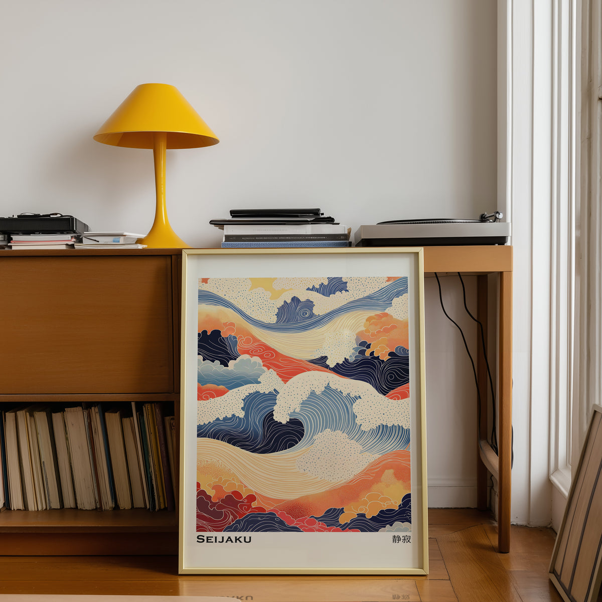 Orange and navy Seijaku waves print shown in a gold frame below a teak desk with a yellow lamp