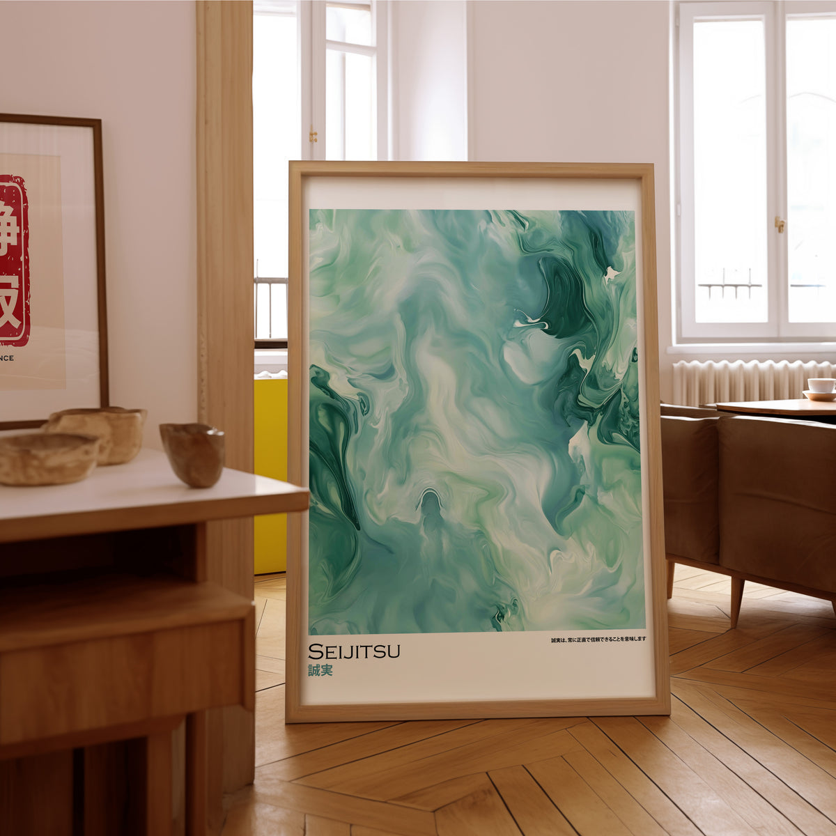 Teal and moss green marble print in an oak frame on the parquet floor of a sunlit living room