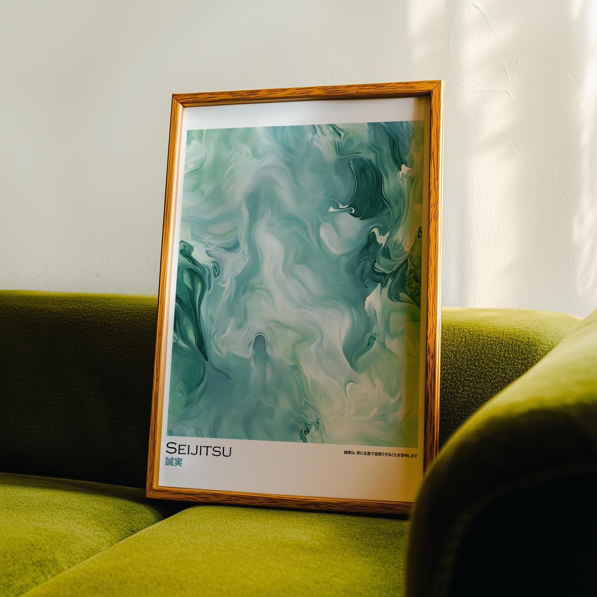 Teal and moss green marble print in an oak frame propped on a green velvet sofa