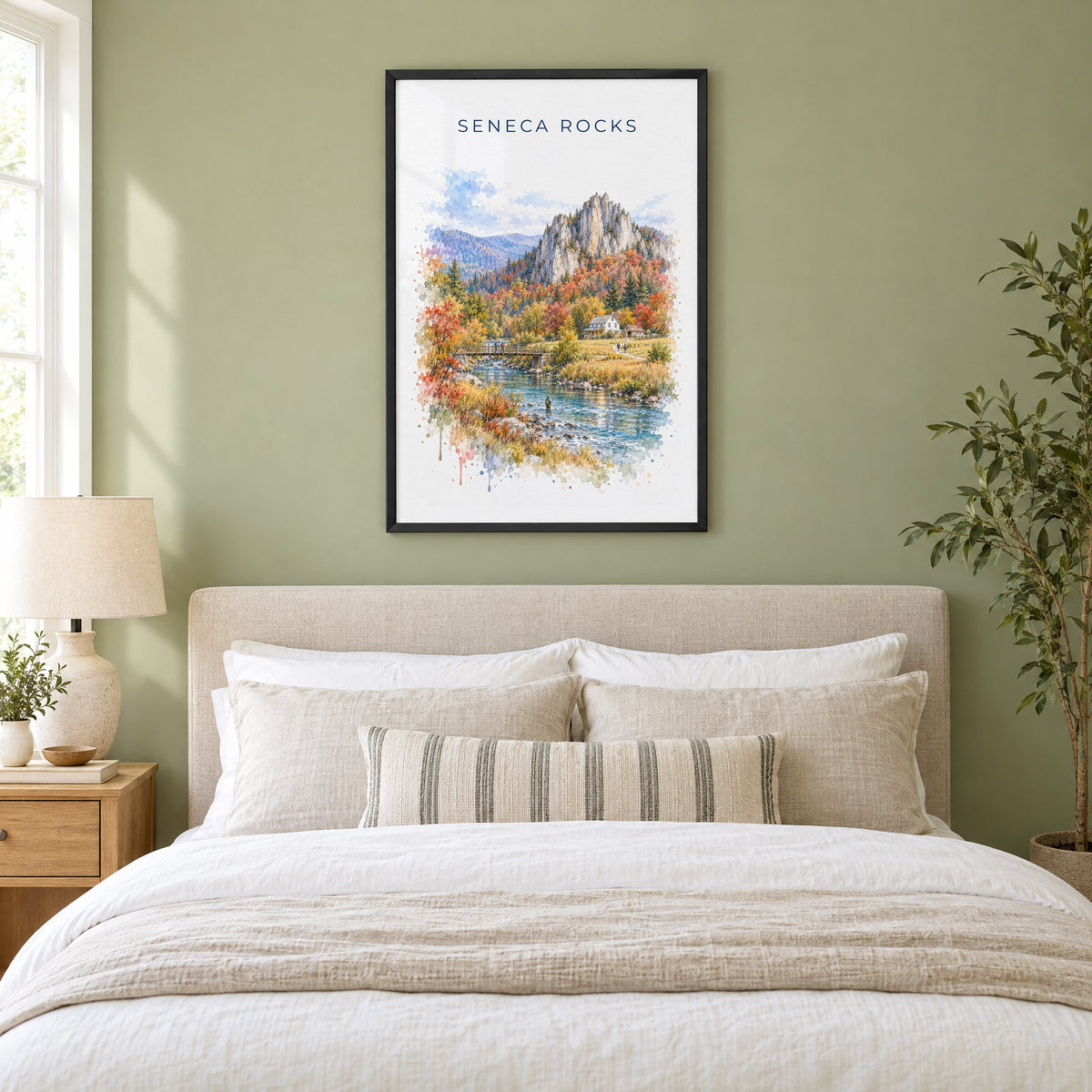 Seneca Rocks watercolor print in a black frame above an upholstered headboard in a sage green bedroom