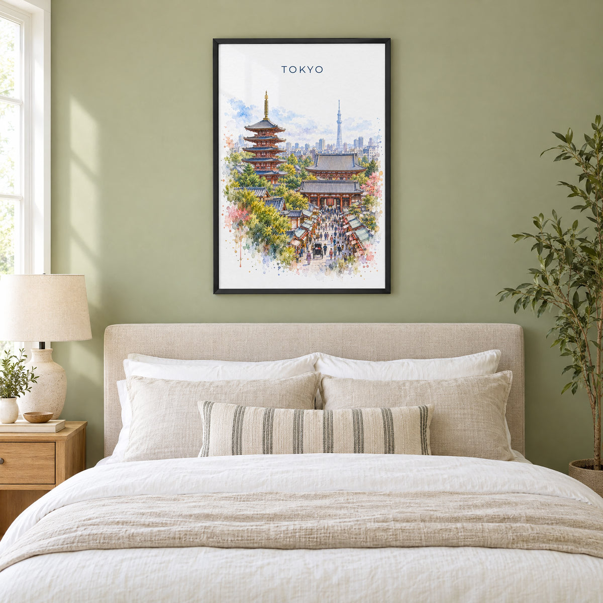 Senso-ji watercolor print in a black frame above an upholstered headboard in a sage green bedroom