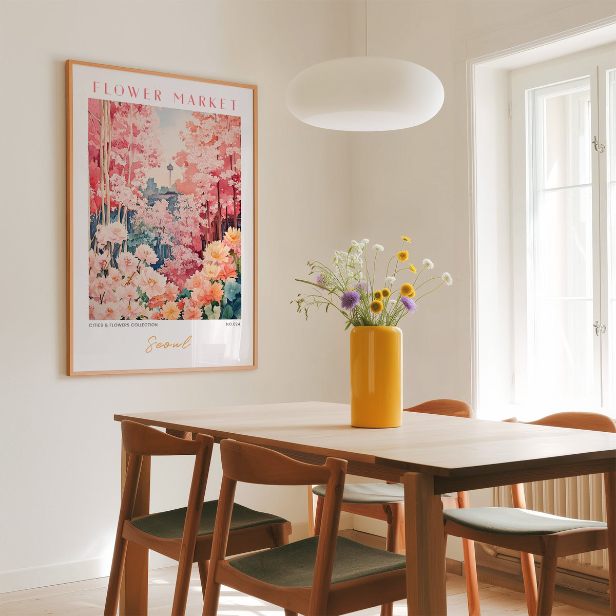 Seoul flower market print in an oak frame above a dining table with a yellow vase and white pendant light