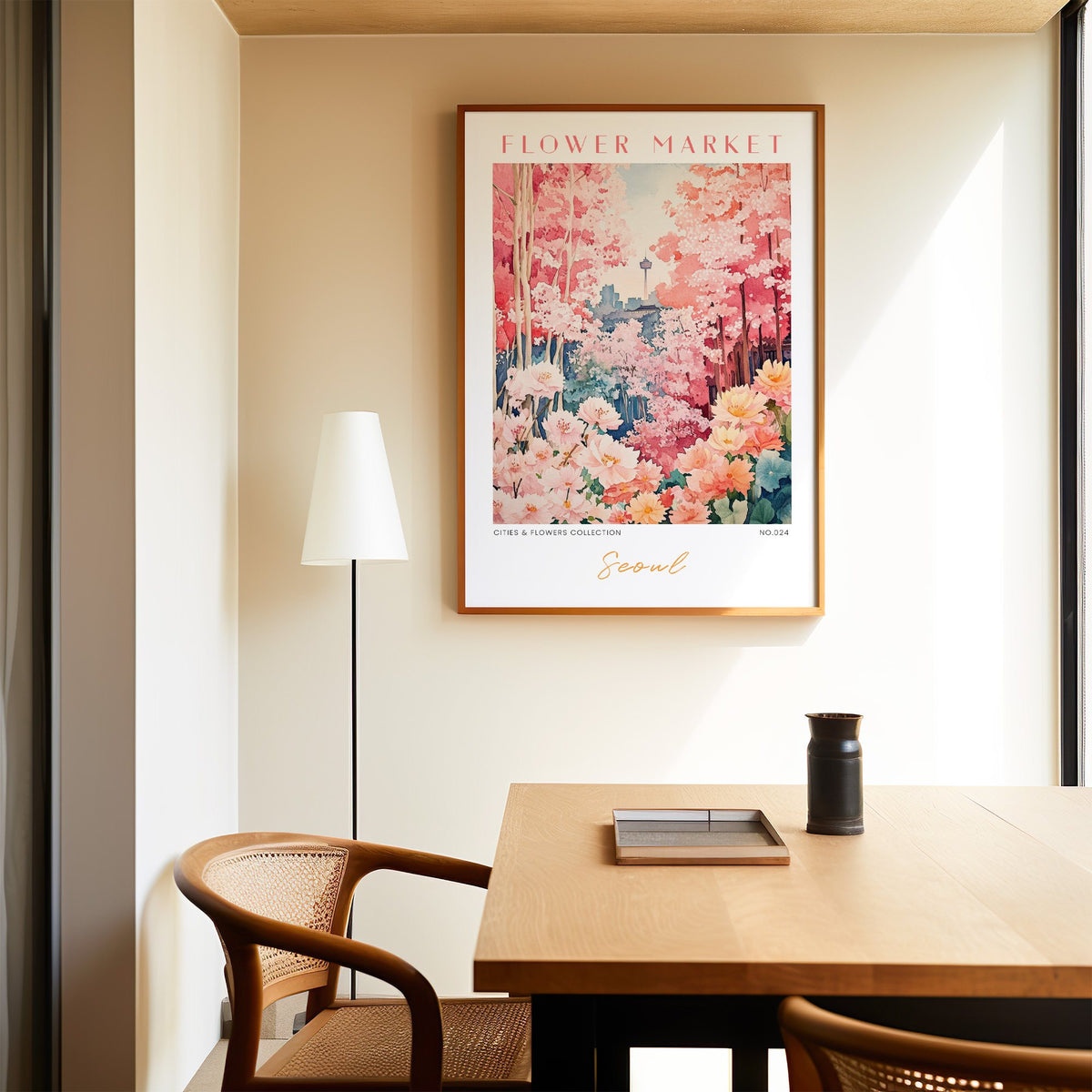 Seoul flower market print in an oak frame above a dining table and cane chair