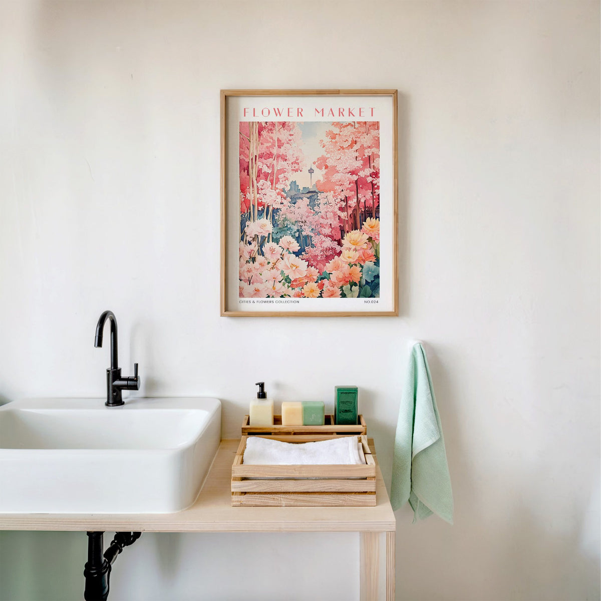 Seoul flower market print in an oak frame above a white bathroom sink with folded towels