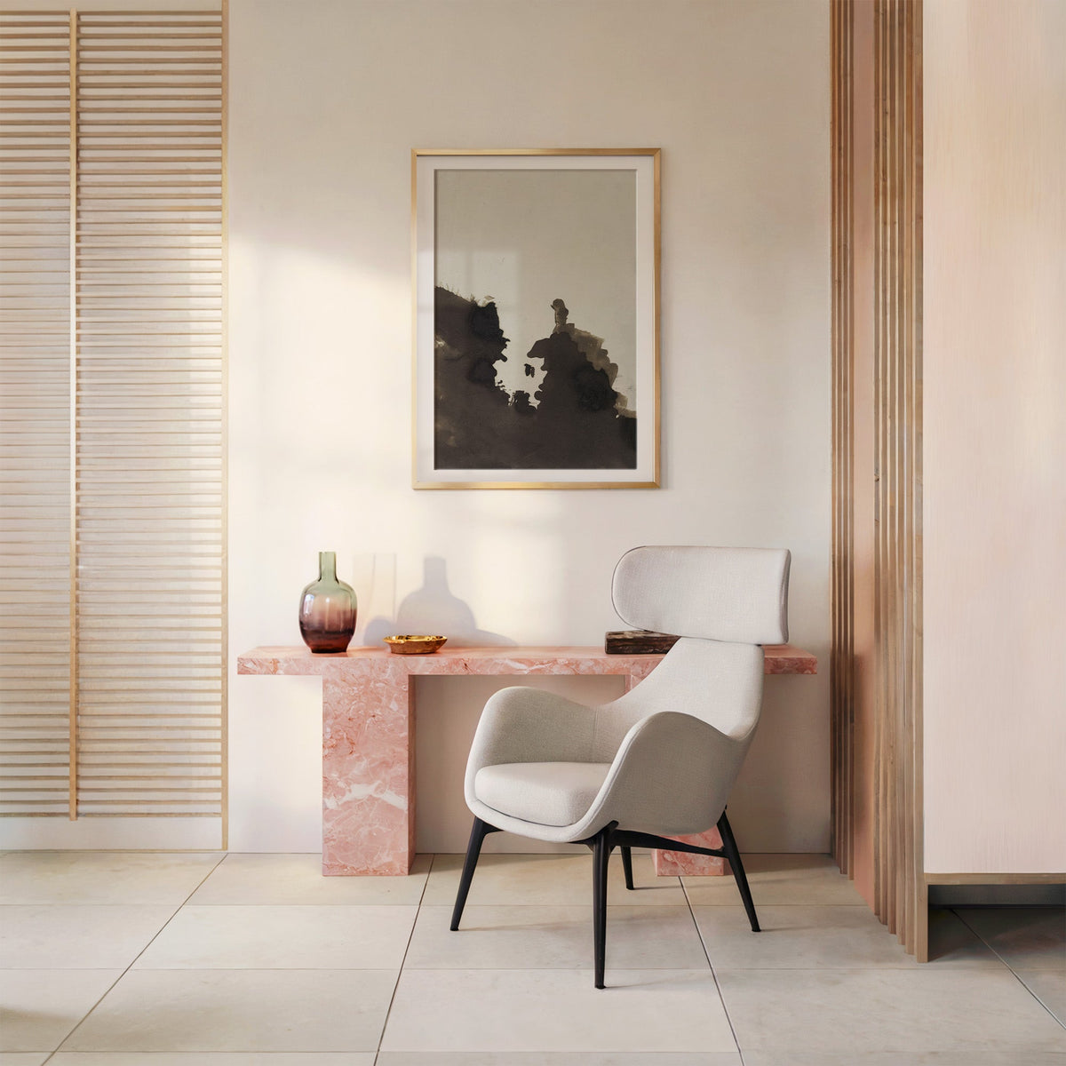 Sepia ink blot facing profiles abstract print shown in a gold frame with a mat above a pink marble console and armchair