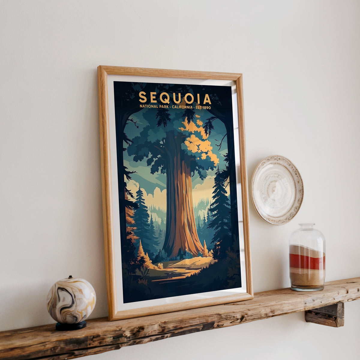 Sequoia National Park print in an oak frame on a rustic wood shelf with ceramics and a sand-filled jar