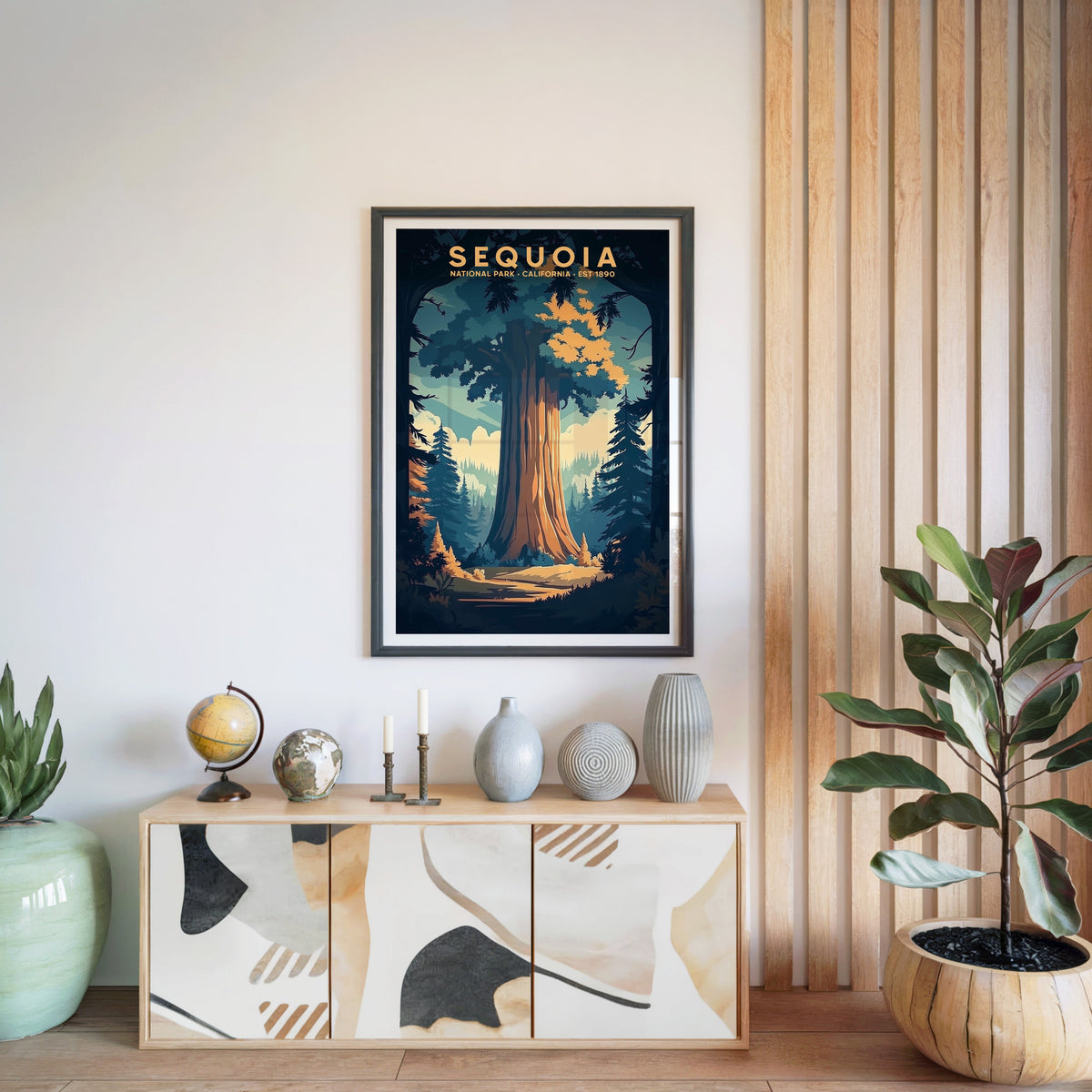 Sequoia National Park print in a black frame above a light wood sideboard with a globe and ceramic vases