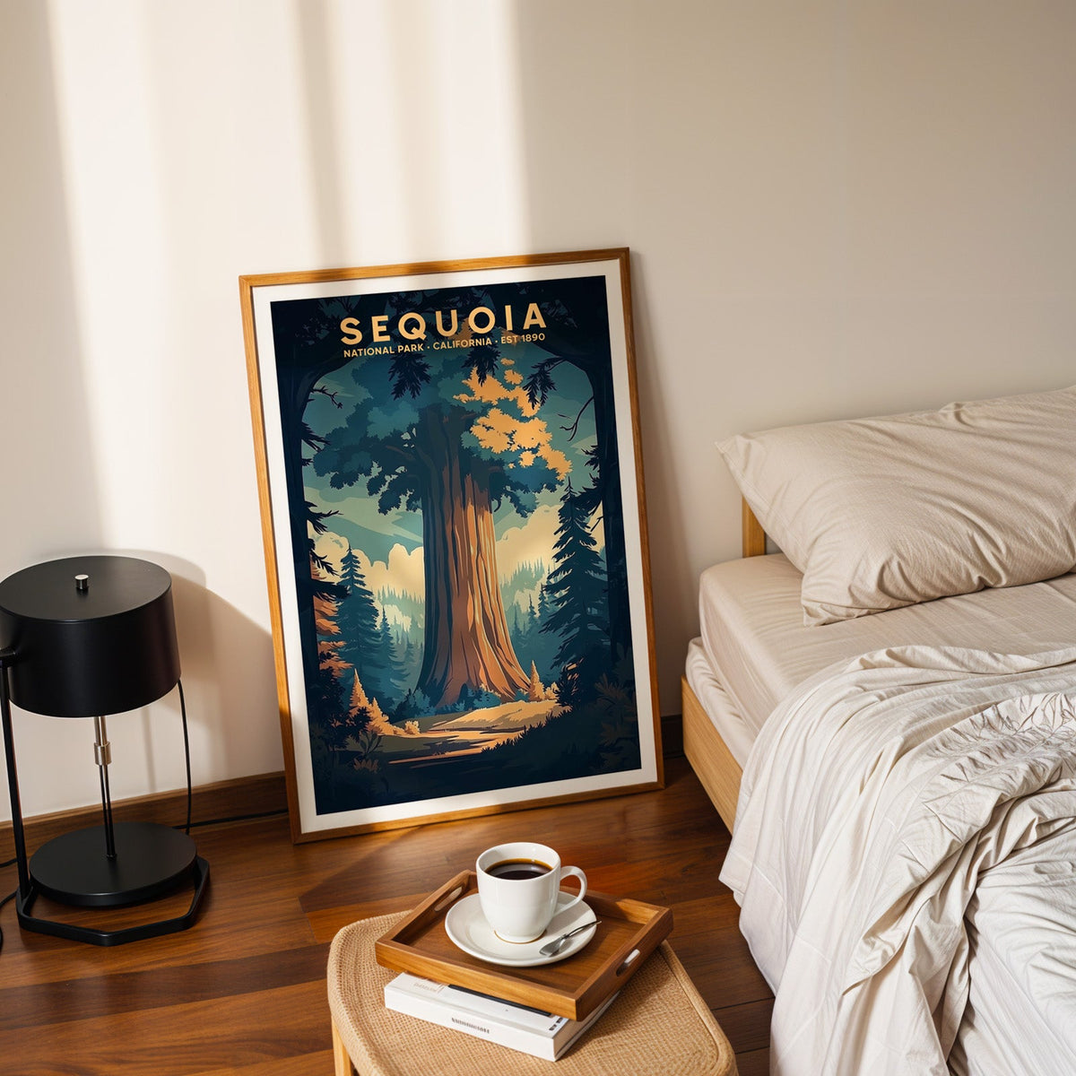 Sequoia National Park print in an oak frame leaning on a bedroom floor beside the bed and a coffee tray
