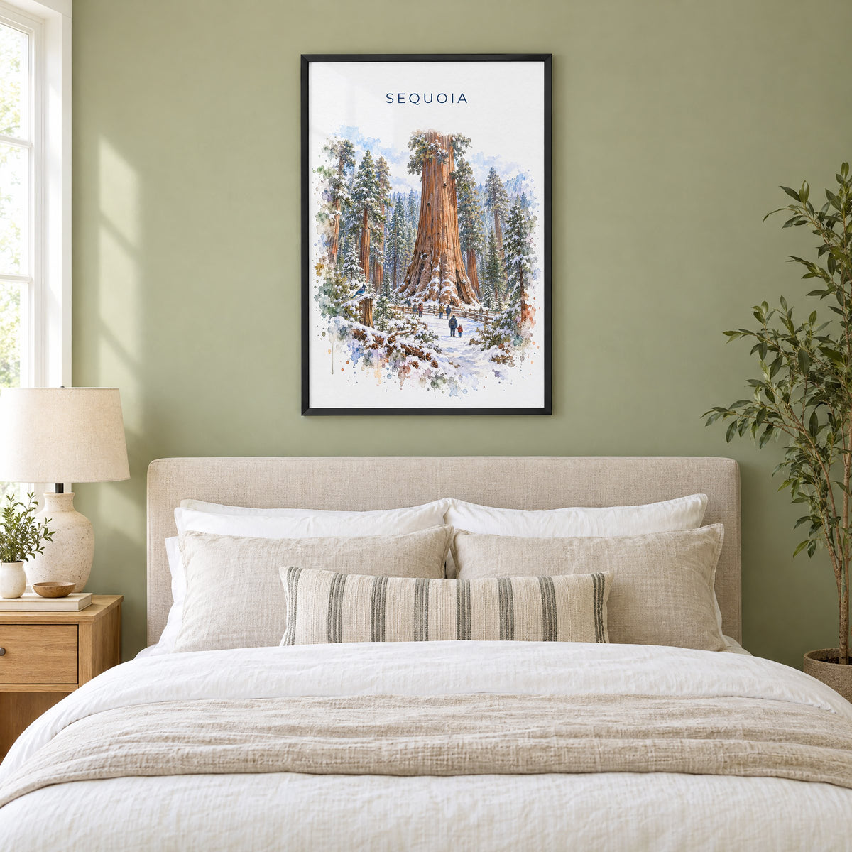 Sequoia National Park watercolor print in a black frame above an upholstered headboard in a sage green bedroom