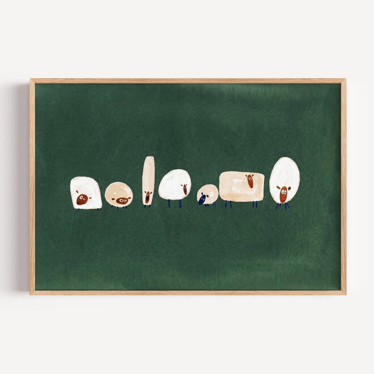 Seven quirky sheep print in a light oak frame on a plain white wall