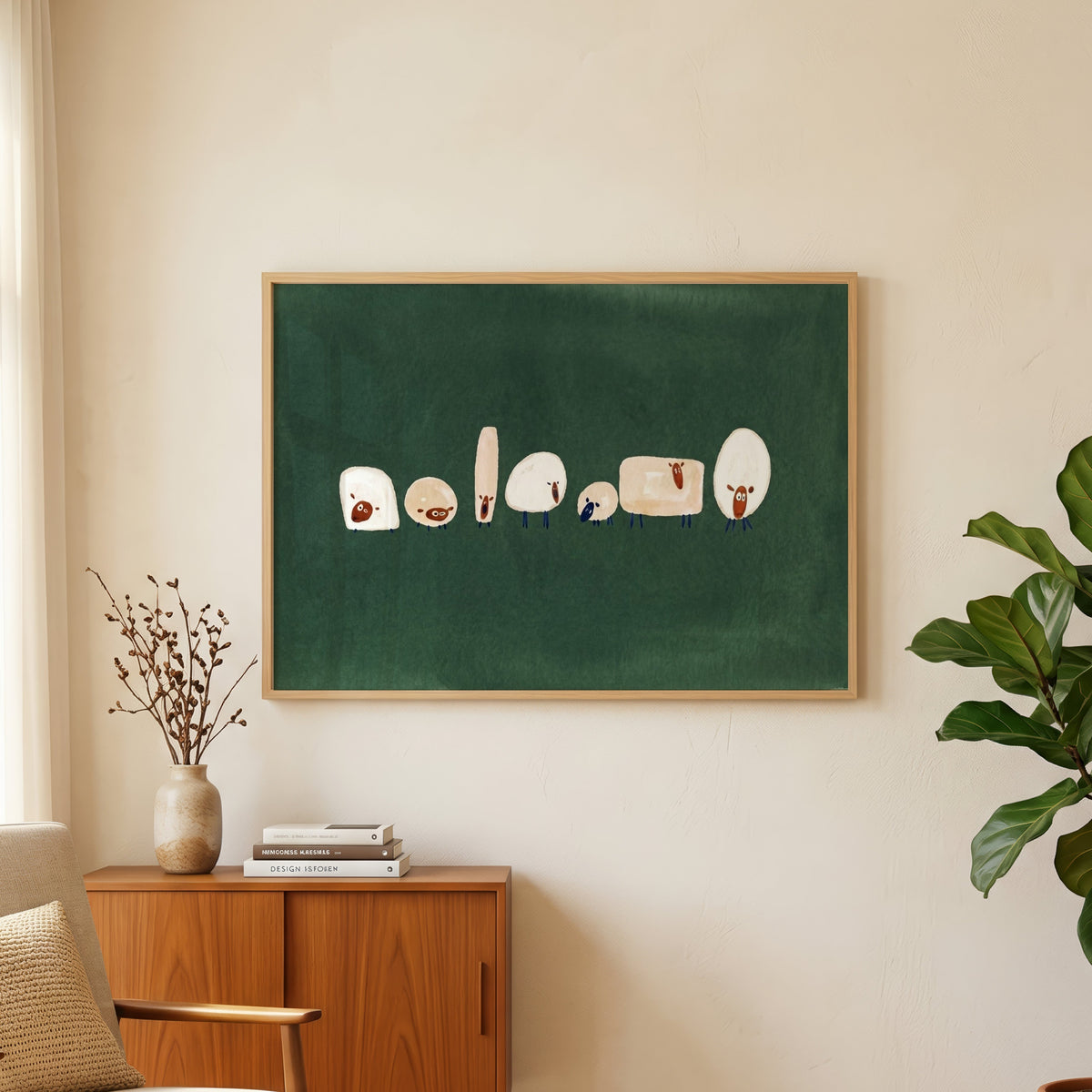 Odd shaped sheep print in an oak frame above a teak sideboard beside a fig tree