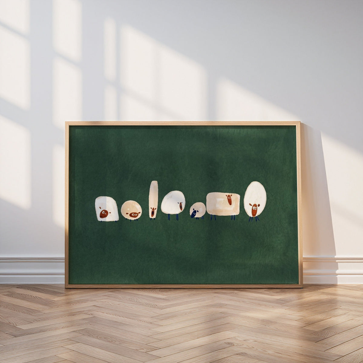 Whimsical flock print in an oak frame leaning on a parquet floor in window light