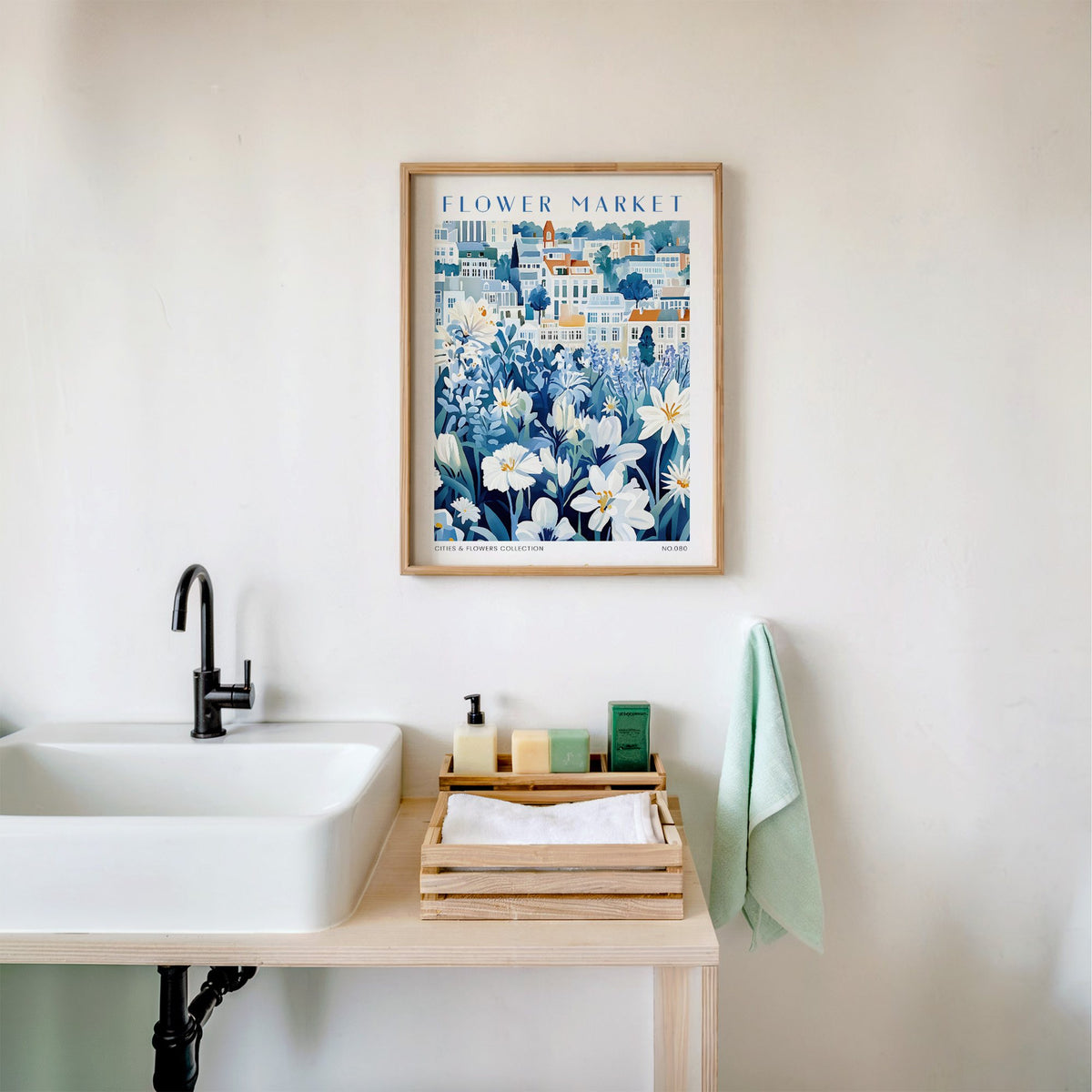 Seville flower market print in an oak frame above a white bathroom sink with folded towels