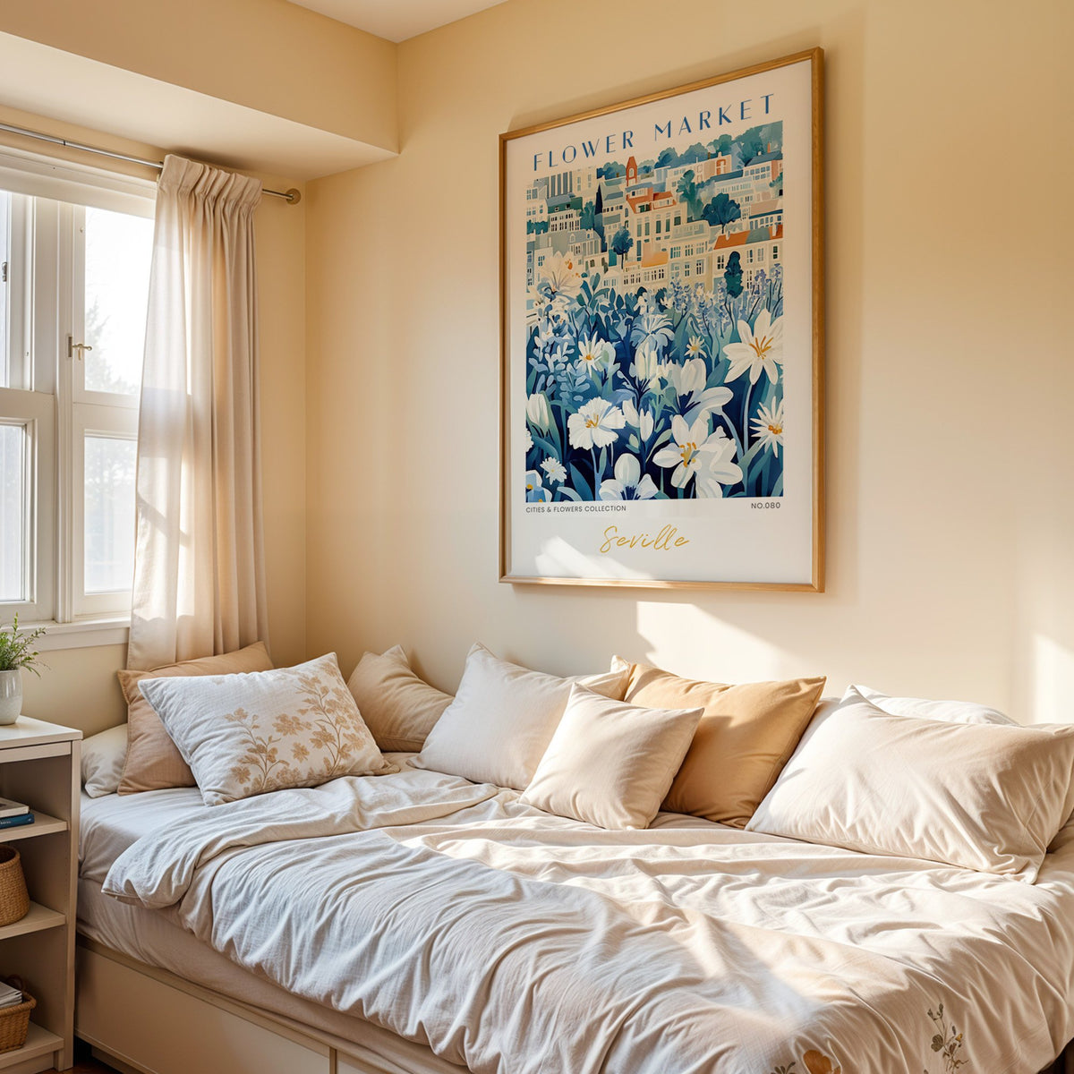 Seville flower market print in an oak frame above a cream daybed in a sunny bedroom