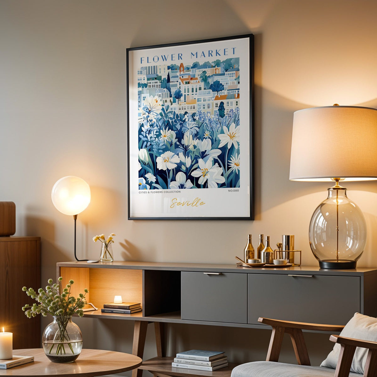 Seville flower market print in a black frame above a grey media console with a glass table lamp
