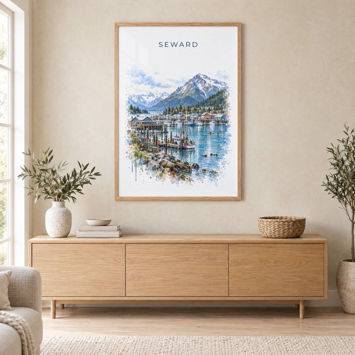 Seward, Alaska watercolor print in an oak frame above a light wood sideboard in a Scandinavian living room