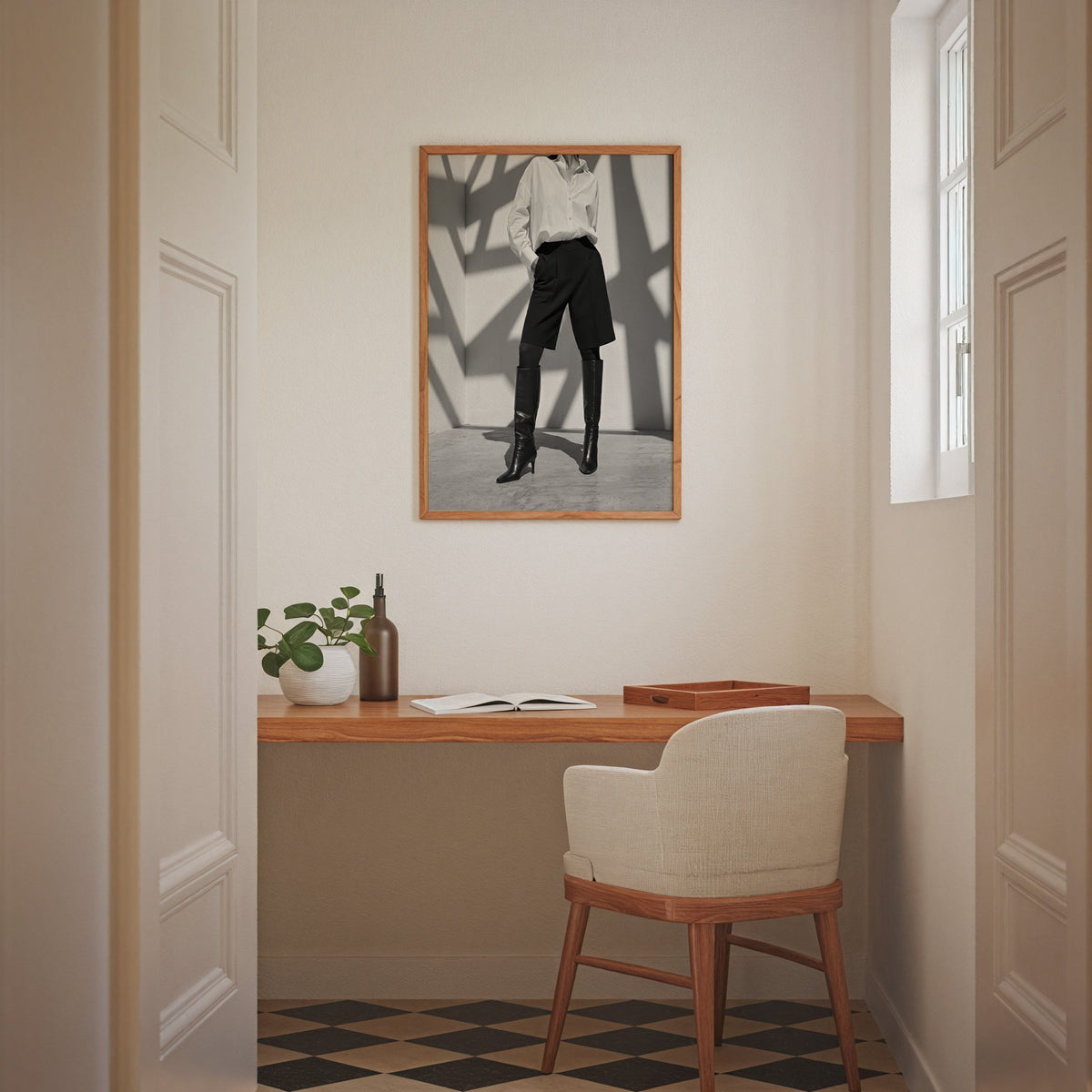 Black and white shirt and knee boots shadow wall print in an oak frame above a home office desk nook