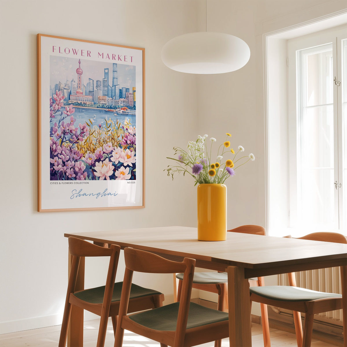 Shanghai flower market print in an oak frame above a dining table with a yellow vase and white pendant light