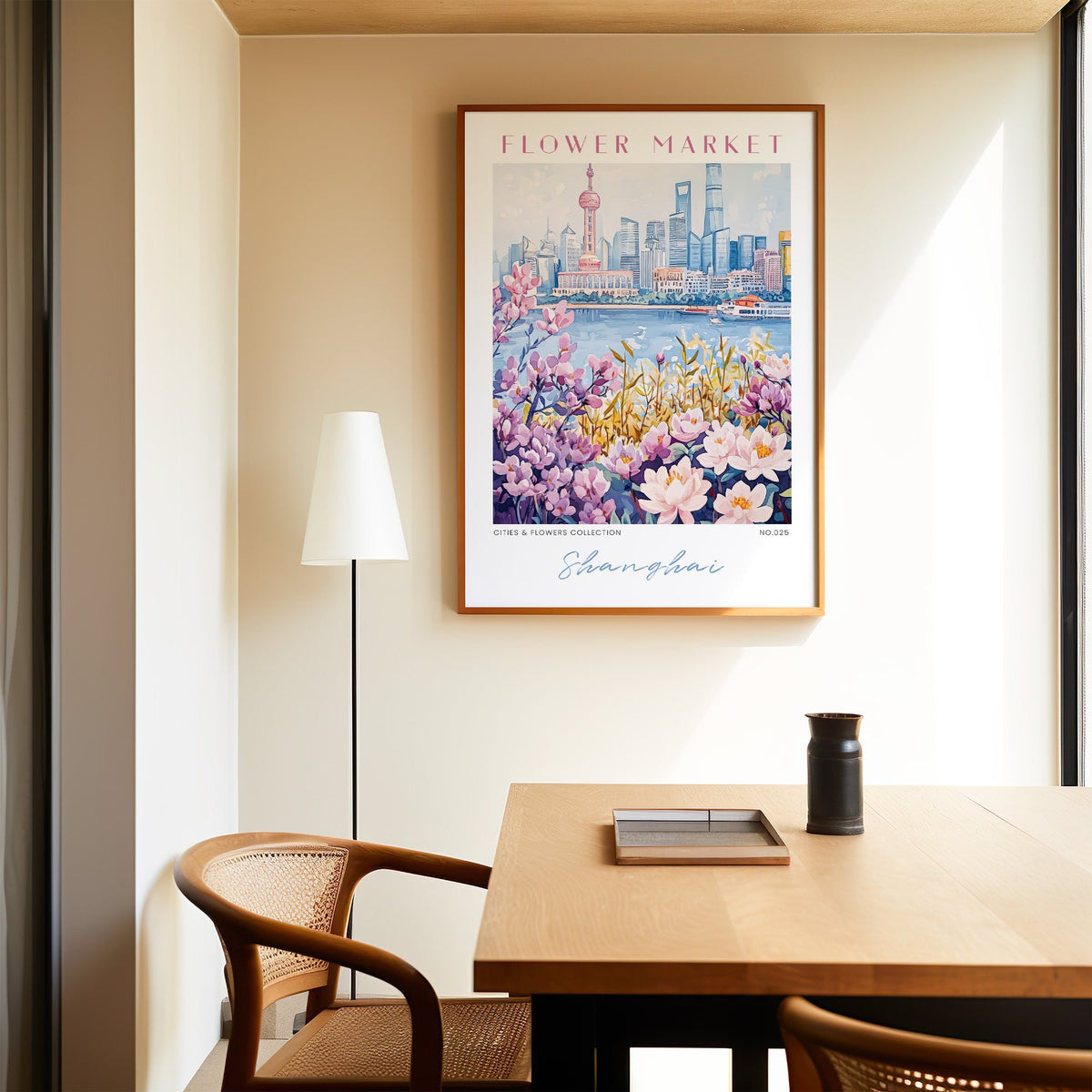 Shanghai flower market print in an oak frame above a dining table and cane chair